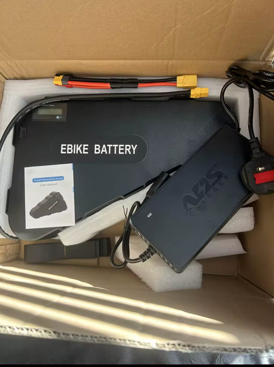 52v 2000w Ebike kit battery from electric conversion kit, featuring a sleek black battery with branding and wiring components.